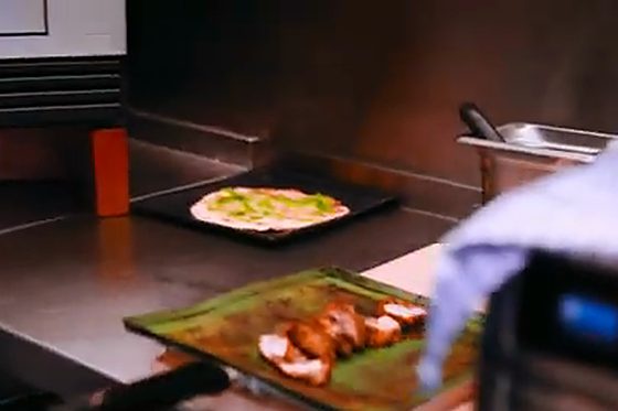 A dish coming out of the SCV3 on a green tray