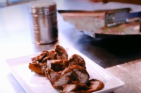 A dish being finished at the pass